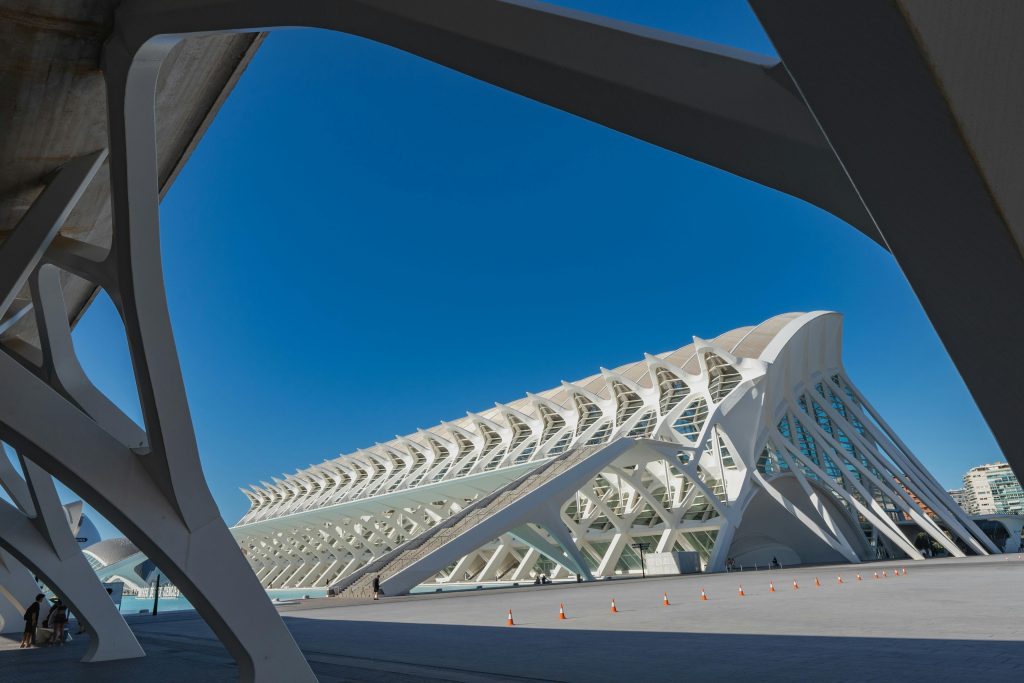 Striking view of futuristic architecture at City of Arts and Sciences, Valencia, Spain under clear blue skies.